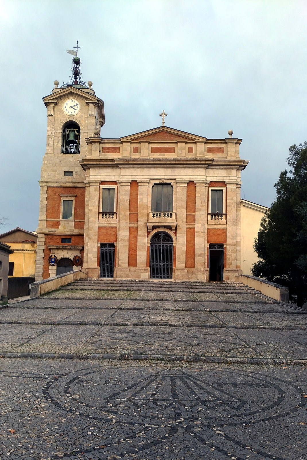 Stone façade and bell tower of the Co-Cathedral of St. Paul above Alatri, Italy.
