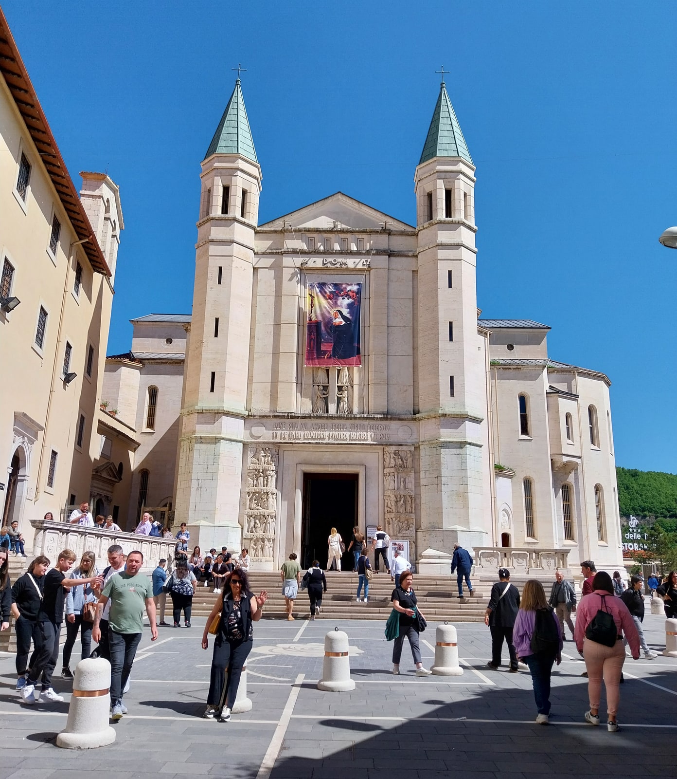 Colorful façade of the Basilica of St. Rita rising above Cascia, Italy.