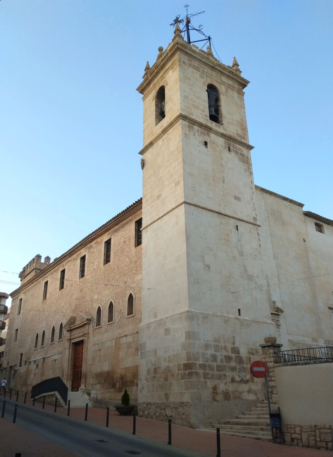 Stone exterior and bell tower of Santiago Apóstol Parish in Onil, Spain.