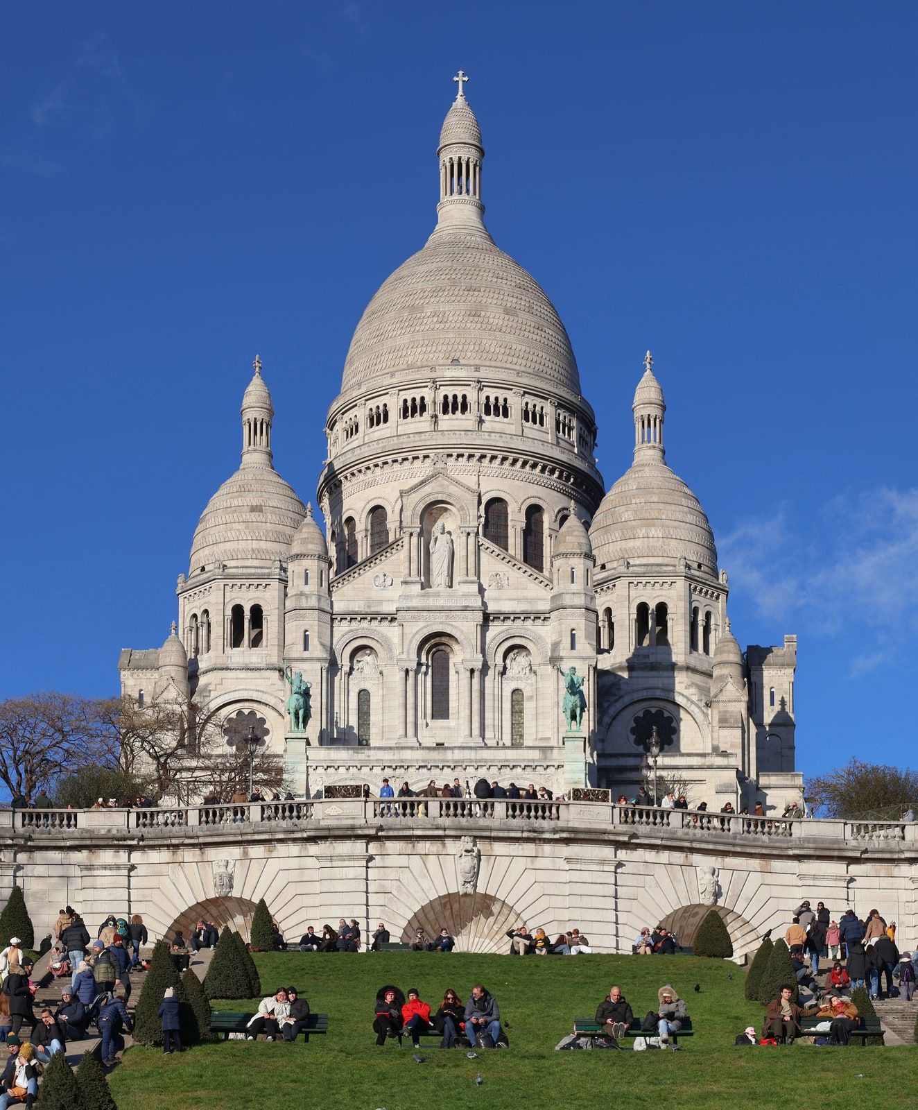 The white domes and south façade of the Basilica of Sacré-Cœur on Montmartre in Paris.