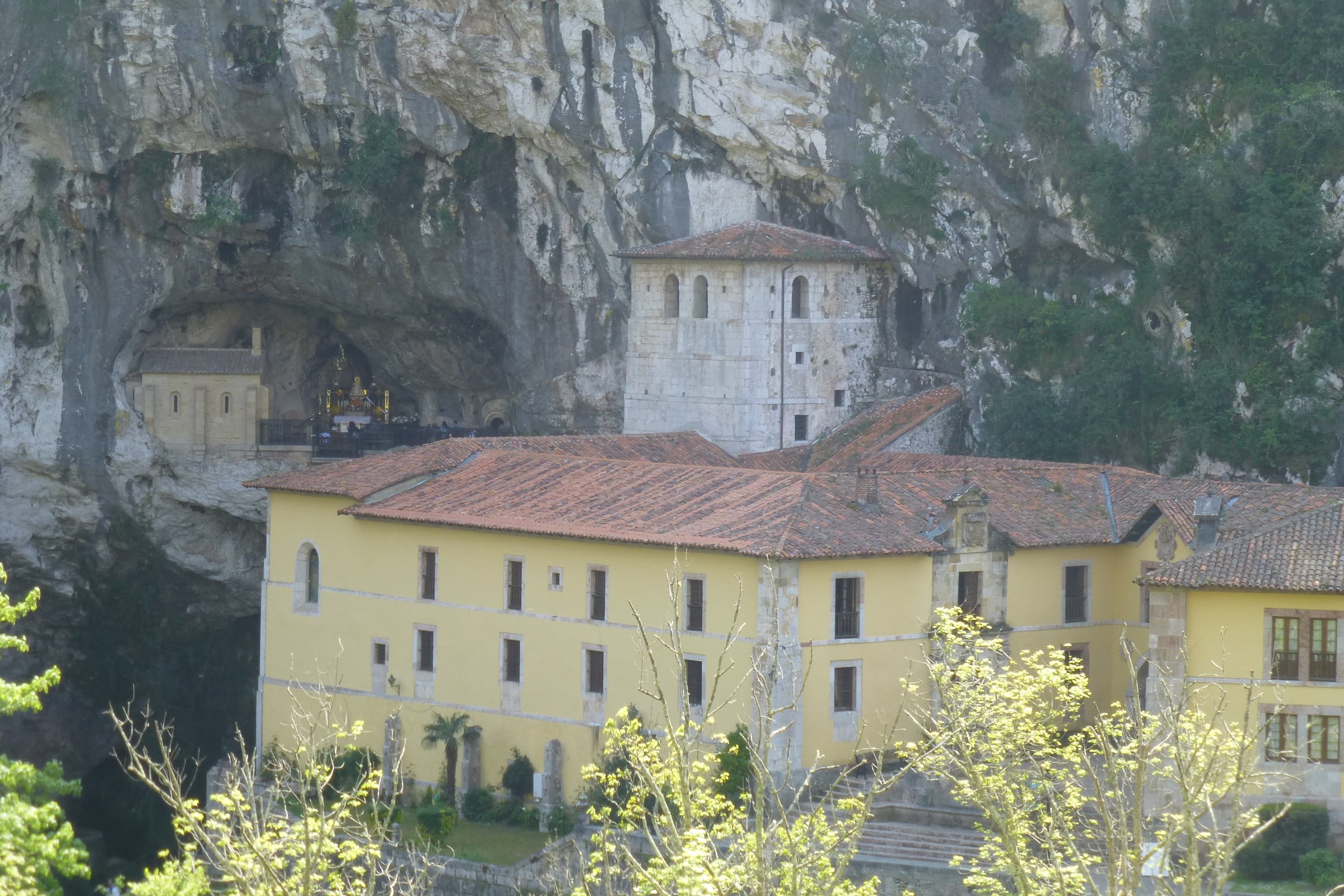 The Holy Cave of Covadonga set into the Asturian mountainside above the sanctuary precinct.