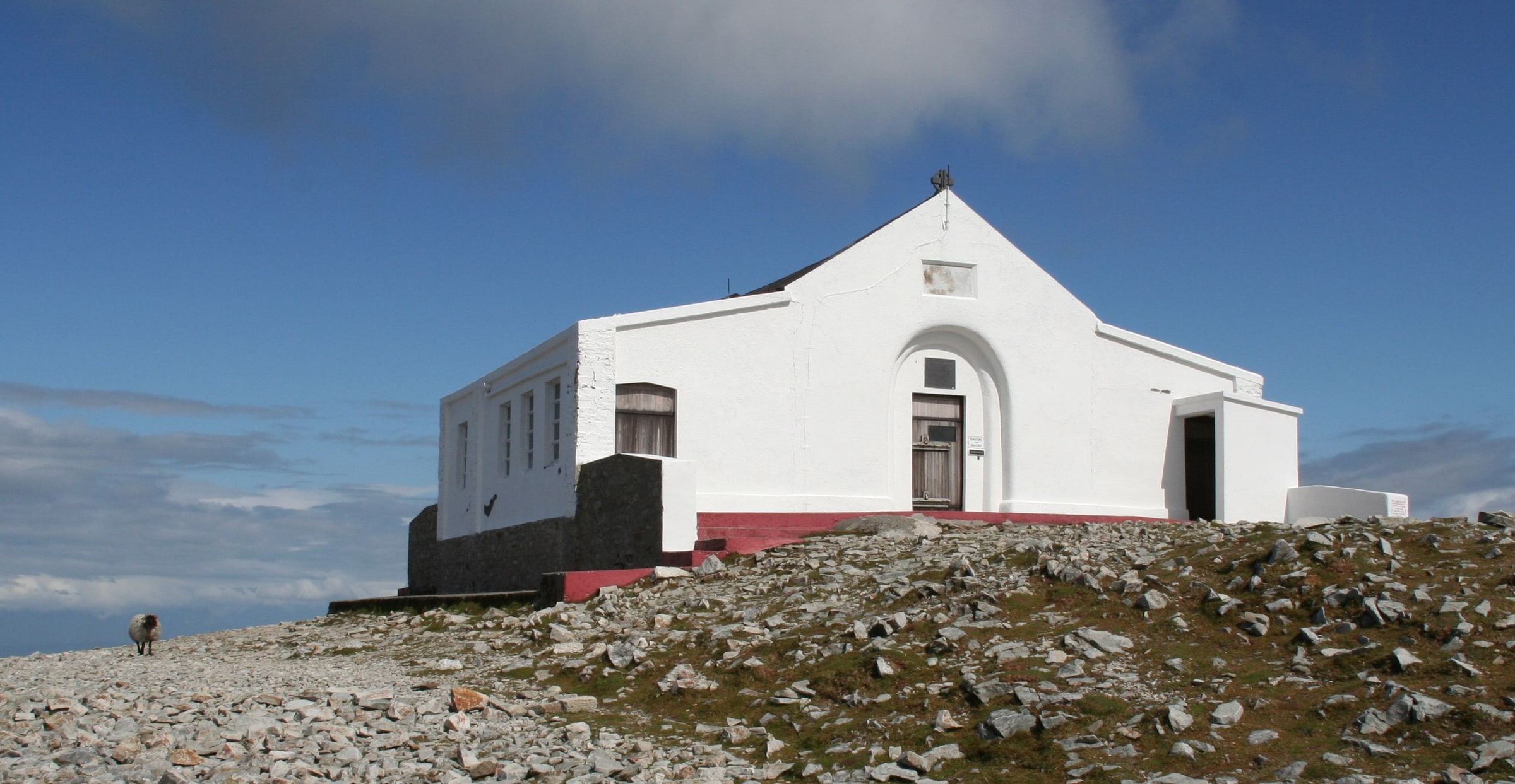 The small white St. Patrick’s Oratory on the rocky summit of Croagh Patrick in County Mayo, Ireland.