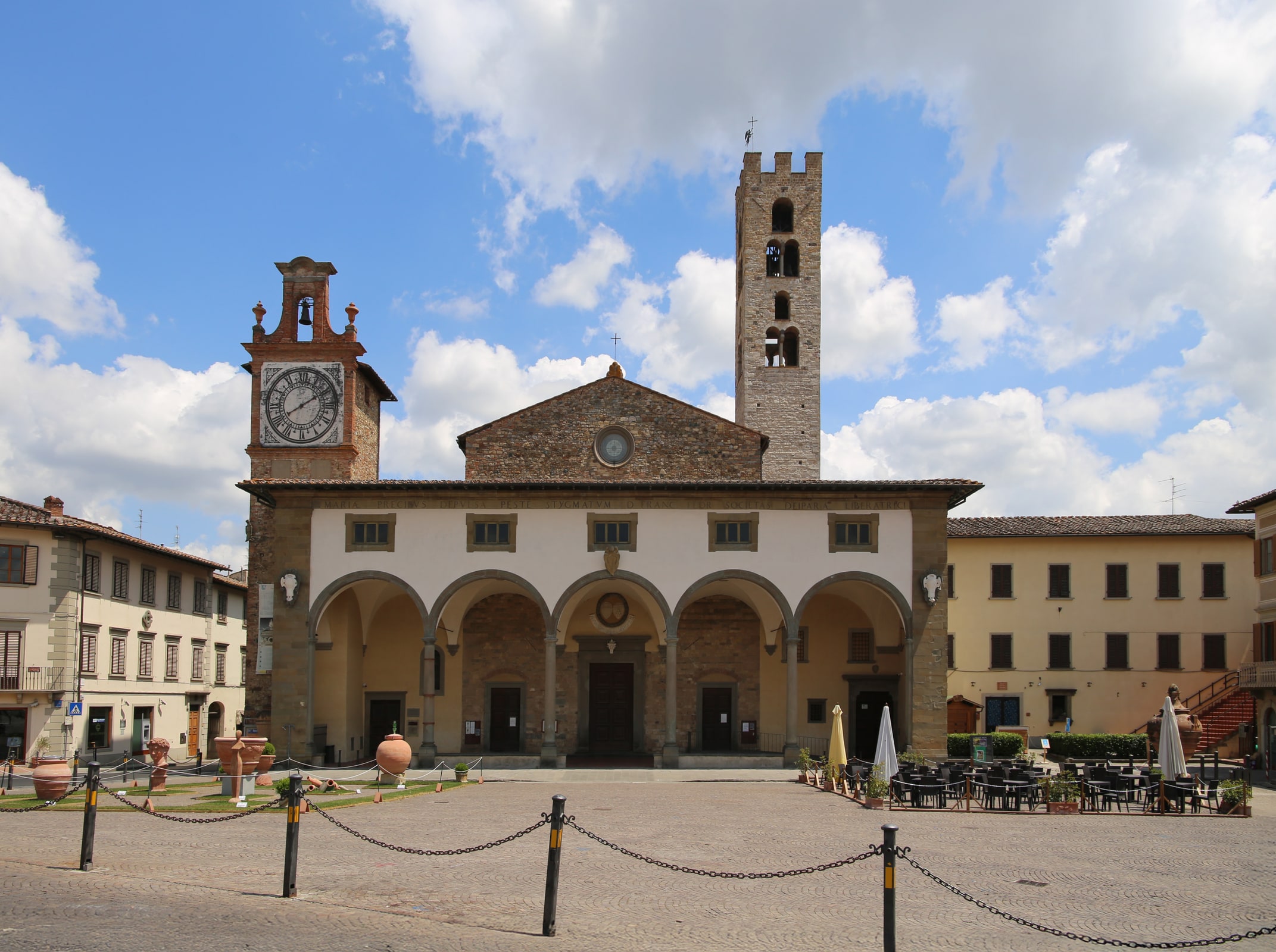 The porticoed facade and bell tower of the Basilica of Santa Maria all’Impruneta in Tuscany.