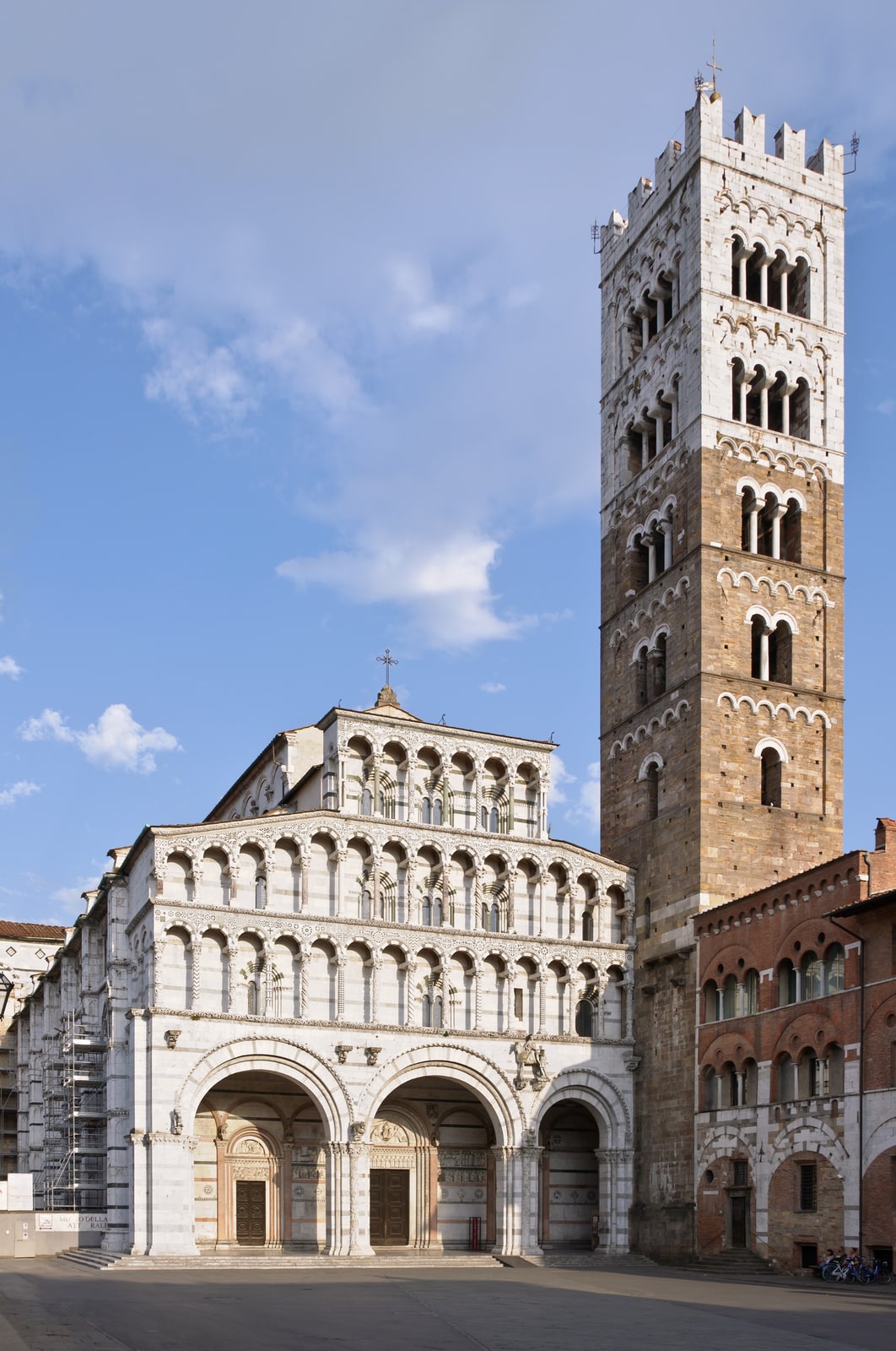 The richly arcaded facade and bell tower of Lucca Cathedral in Piazza San Martino.