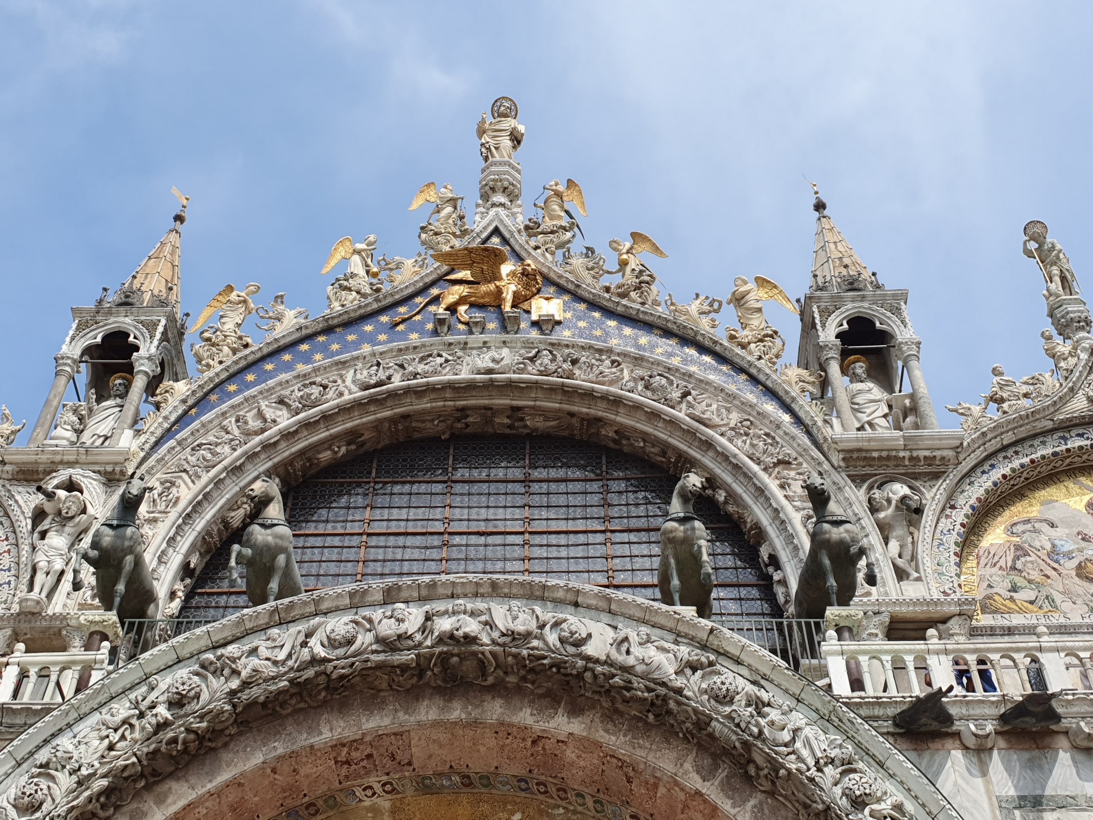 The domes and richly decorated facade of St. Mark’s Basilica in Venice.