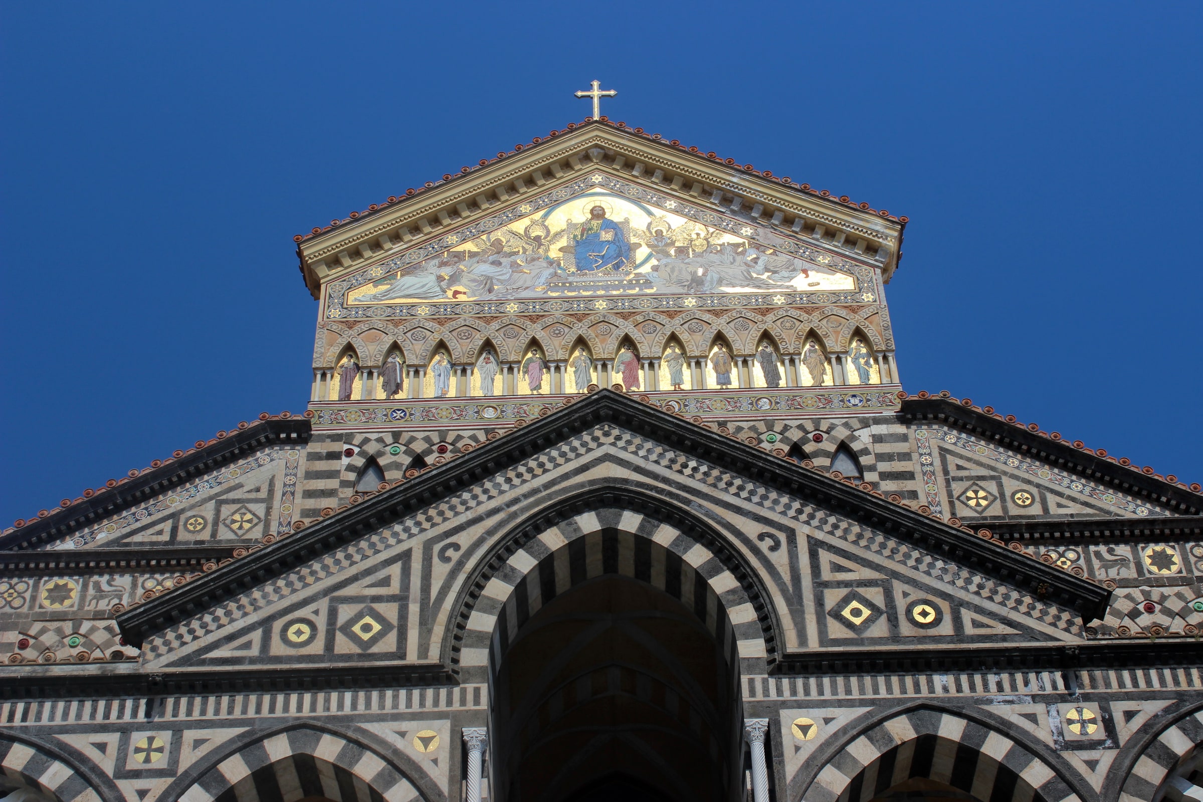 The striped facade, mosaic gable, and monumental stair of Amalfi Cathedral.