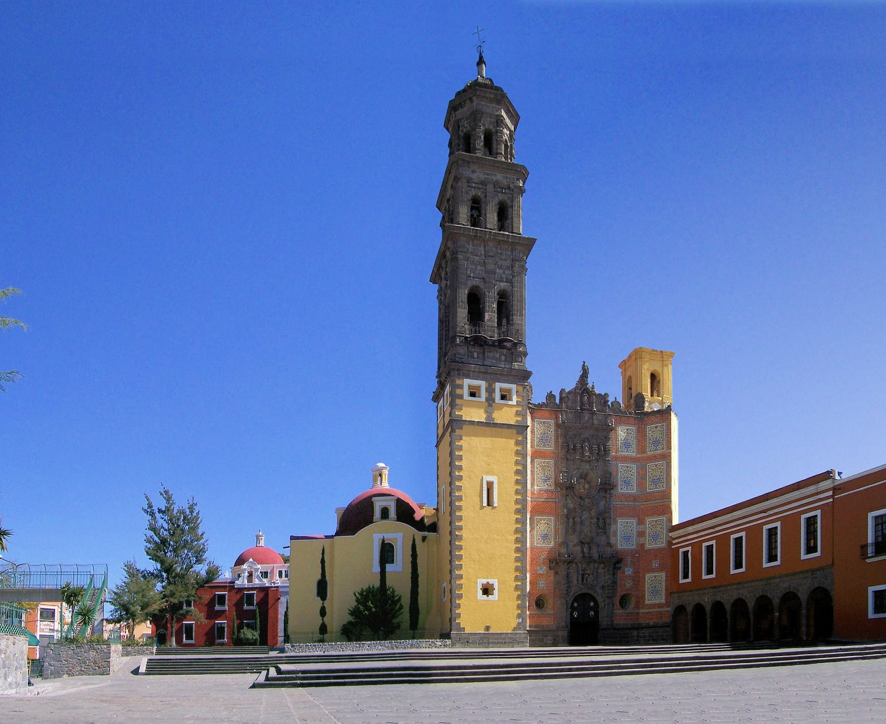 The richly decorated façade and bell tower of the Church of San Francisco in Puebla, Mexico.