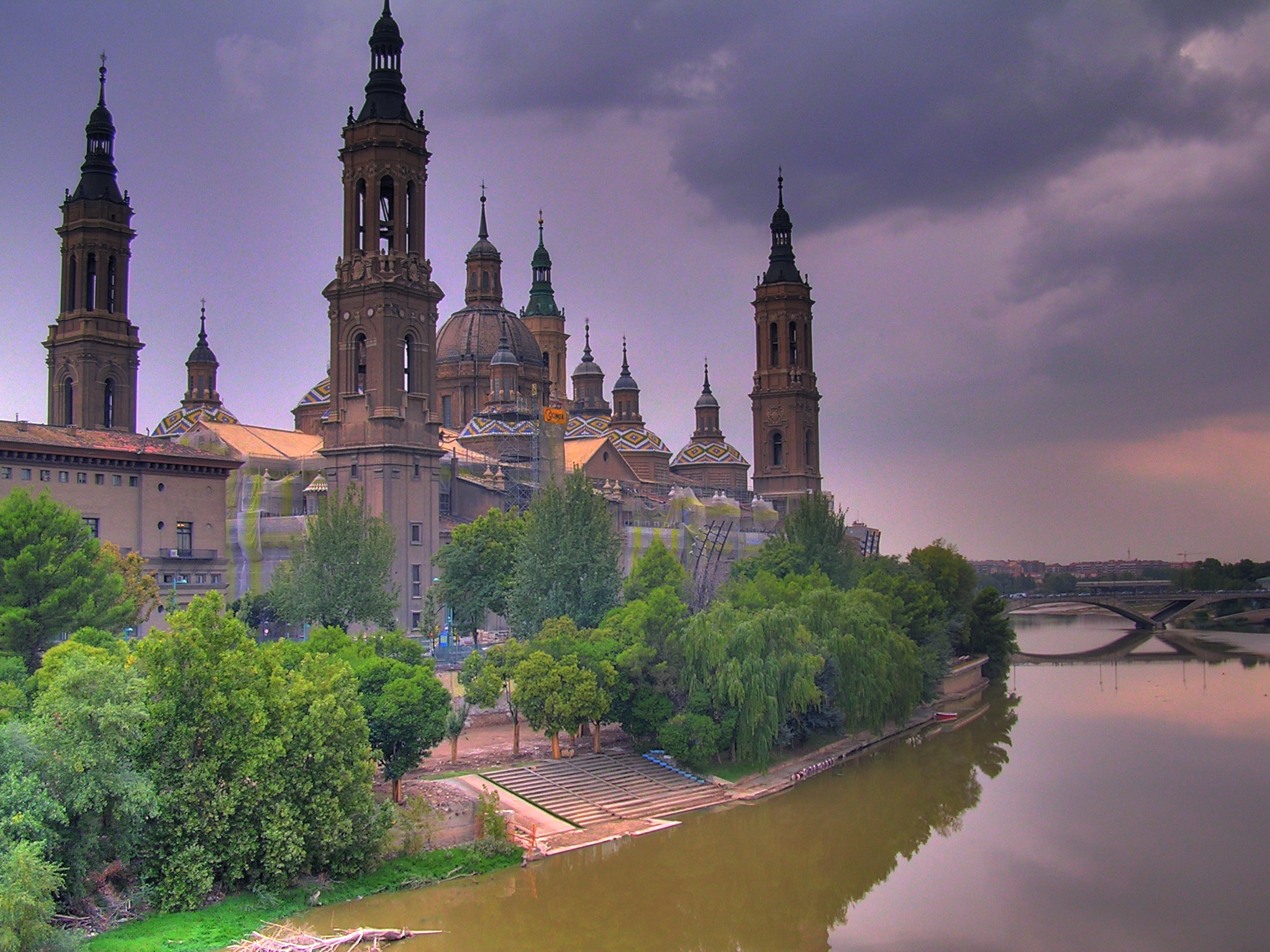 The Cathedral-Basilica of Our Lady of the Pillar rising beside the Ebro River in Zaragoza, Spain.