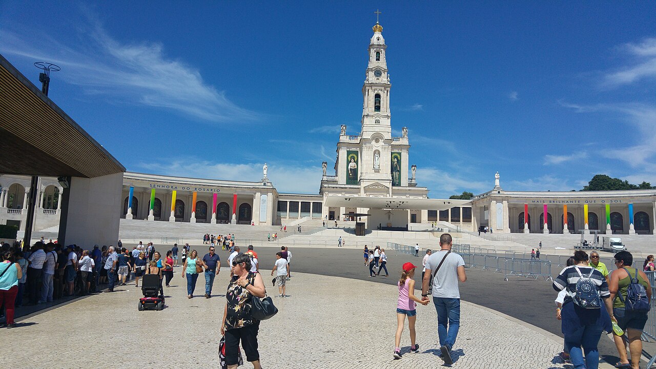 Pilgrims cross the prayer area before the Basilica of Our Lady of the Rosary at the Sanctuary of Fátima in Portugal.