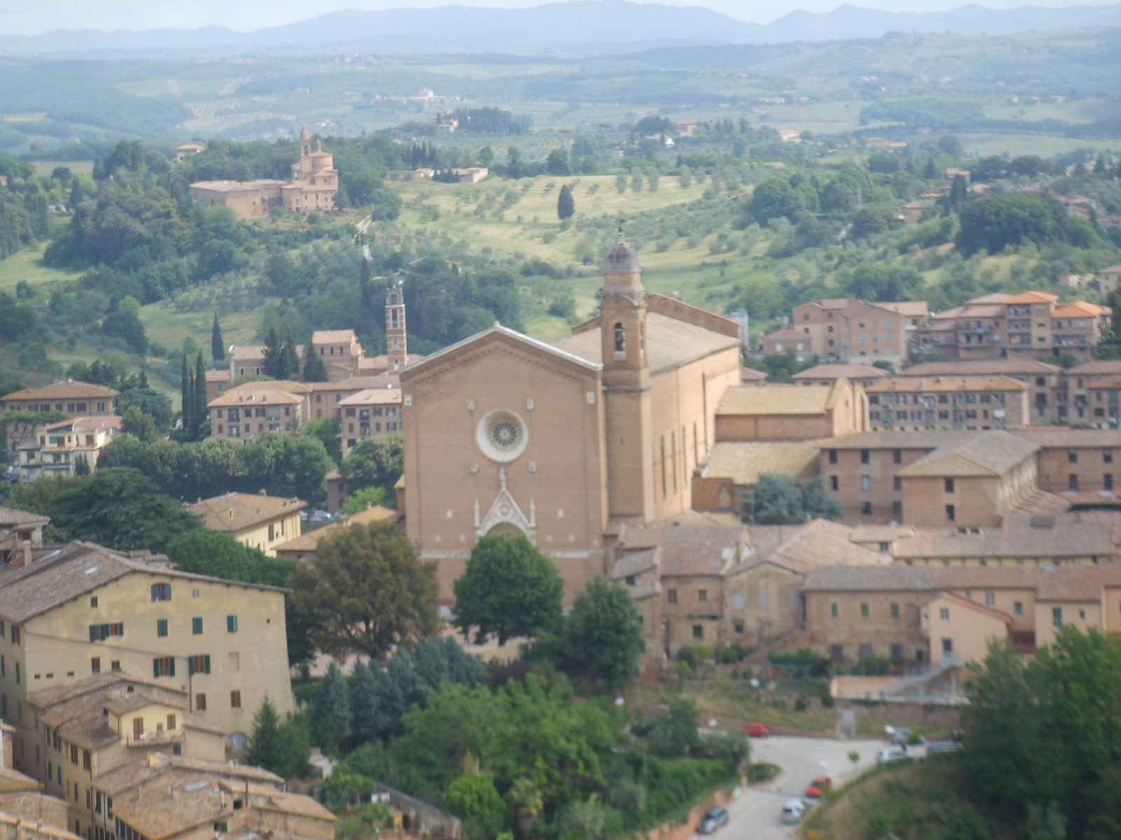 The brick Basilica of San Francesco rising above the rooftops of Siena.