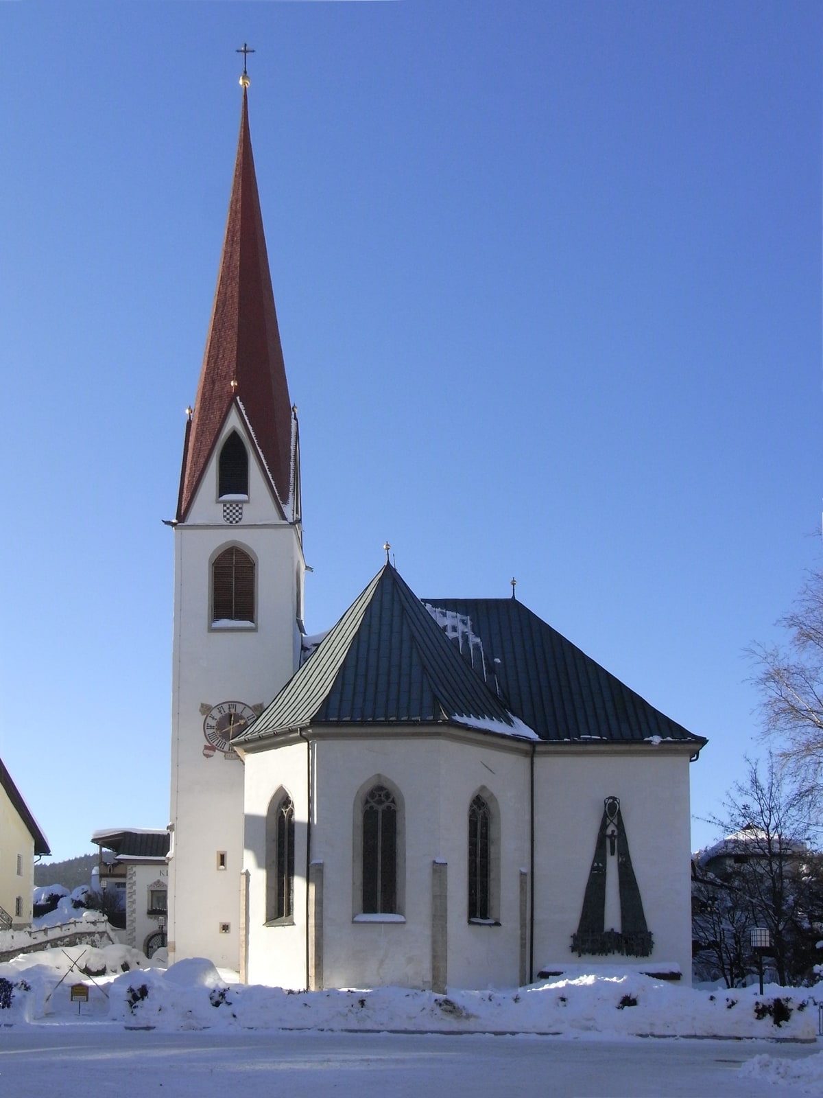 Snow-covered late-Gothic St. Oswald Parish Church in Seefeld in Tirol, Austria.