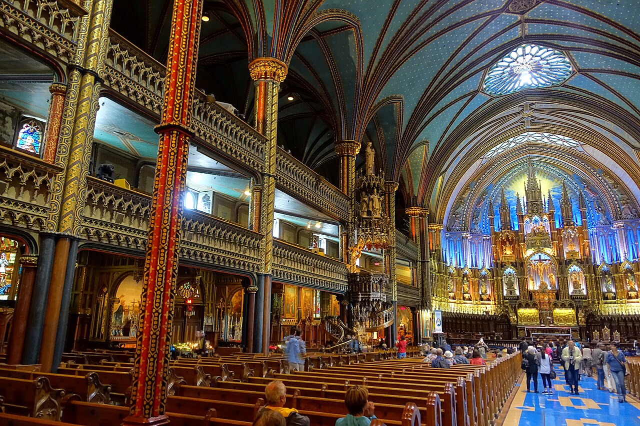 The blue-and-gold Gothic Revival interior of Notre-Dame Basilica of Montreal, viewed toward the sanctuary