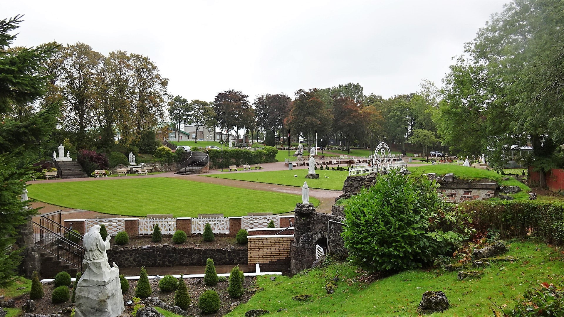 A wide view across the chapels and devotional landscape of Carfin Grotto in Scotland.