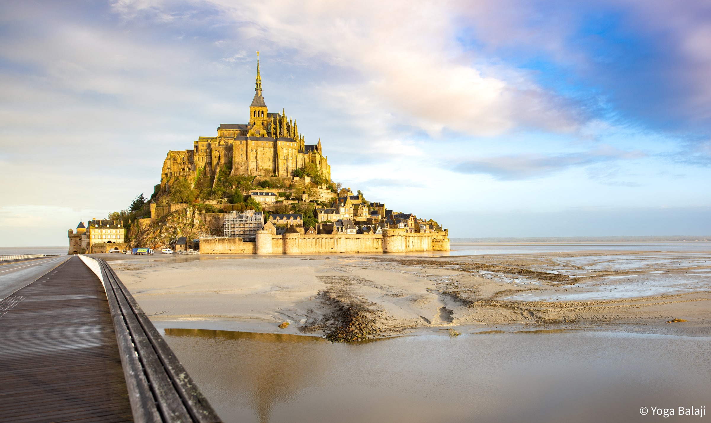 Mont-Saint-Michel Abbey rising above the tidal bay in Normandy, France, seen across the surrounding flats.
